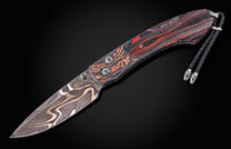 Damascus steel knife with red and black striped handle by B12, featuring intricate blade patterns and silver hardware, side view on dark background