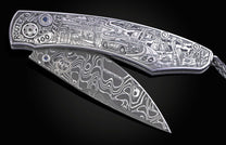Hand engraved William Henry knife with depictions of Route 66 on a black background