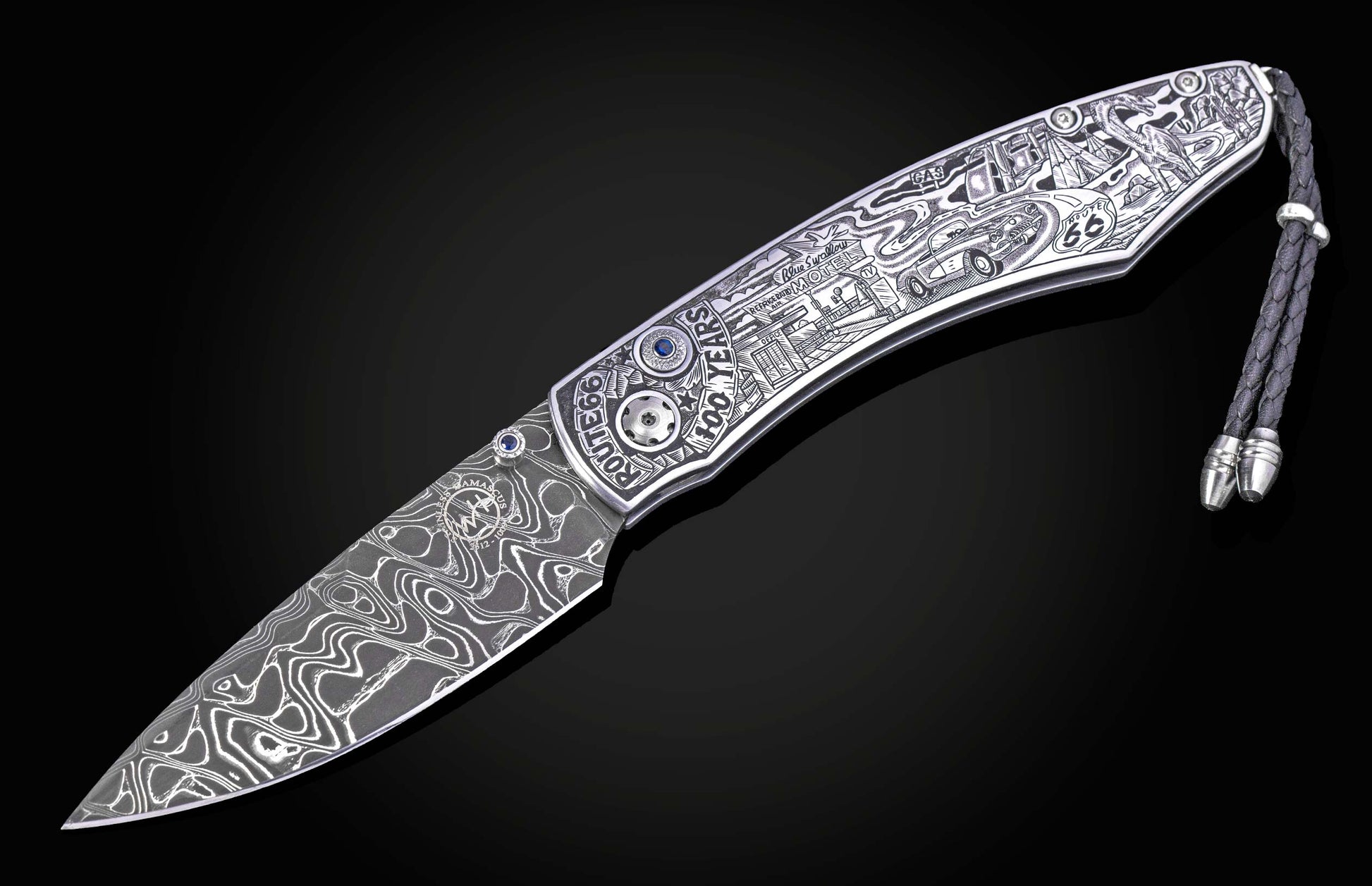 Hand engraved William Henry knife with depictions of Route 66 on a black background