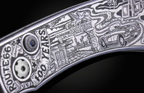 Hand engraved William Henry knife with depictions of Route 66 on a black background