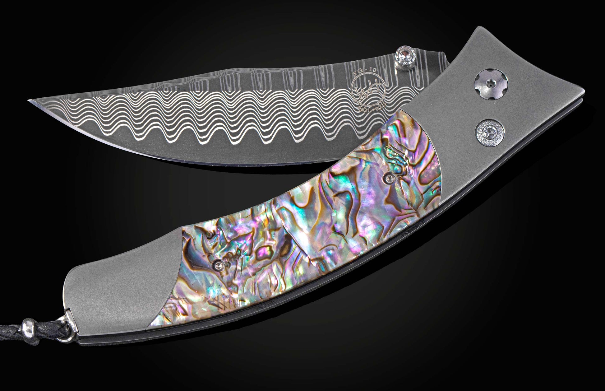 Foldable knife with abalone shell handle on a black background