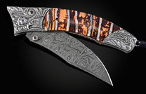 Decorative knife with ornate handle and blade on a dark background