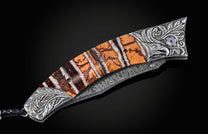 Decorative knife with an ornate handle on a black background