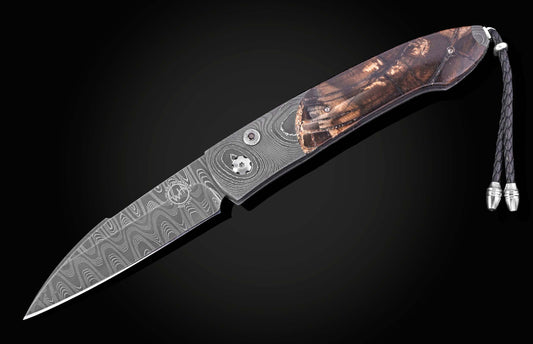 Damascus steel knife with fossil mammoth tusk scales. Displayed open on a black background.