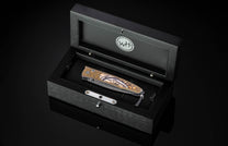 William Henry folding knife with gold koftgari designs, fossil wooly mammoth tusk, and damascus steel blade