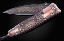 William Henry knife featuring coper & carbon fiber scales and a superconductor frame