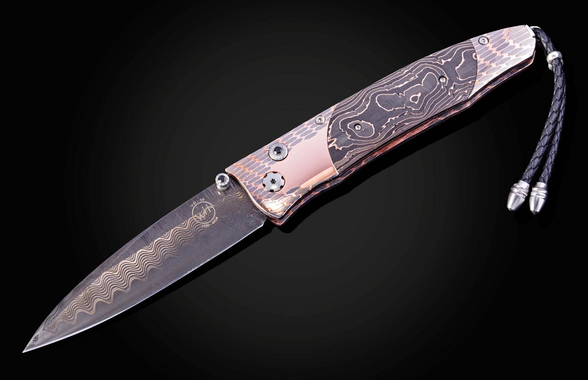 William Henry knife featuring coper & carbon fiber scales and a superconductor frame
