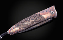 William Henry knife featuring coper & carbon fiber scales and a superconductor frame