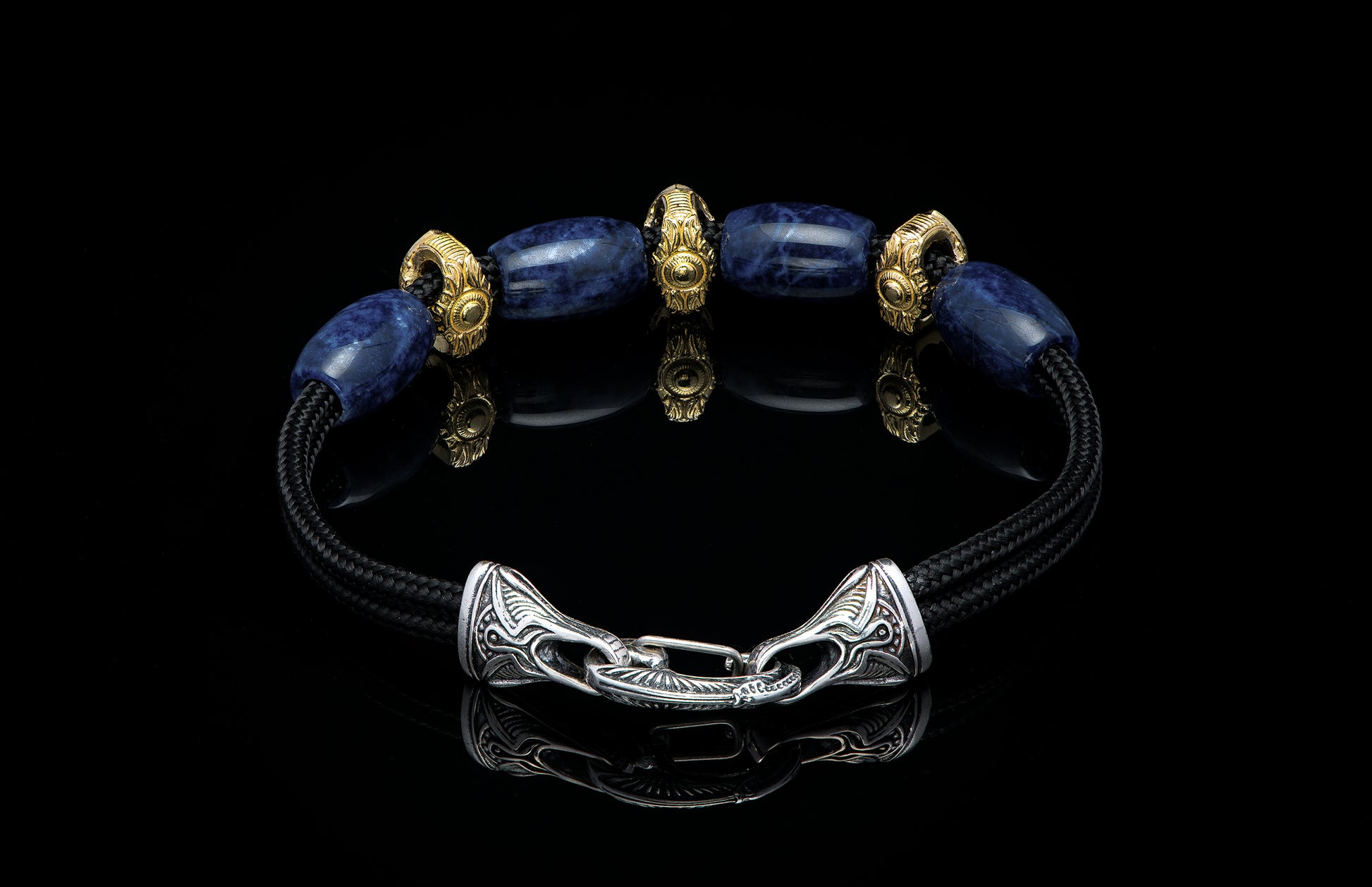 Bracelet featuring sodalite and gold beads with silver clasp