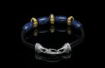 Bracelet featuring sodalite and gold beads with silver clasp