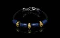 Bracelet featuring sodalite and gold beads with silver clasp