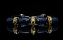 Bracelet featuring sodalite and gold beads with silver clasp