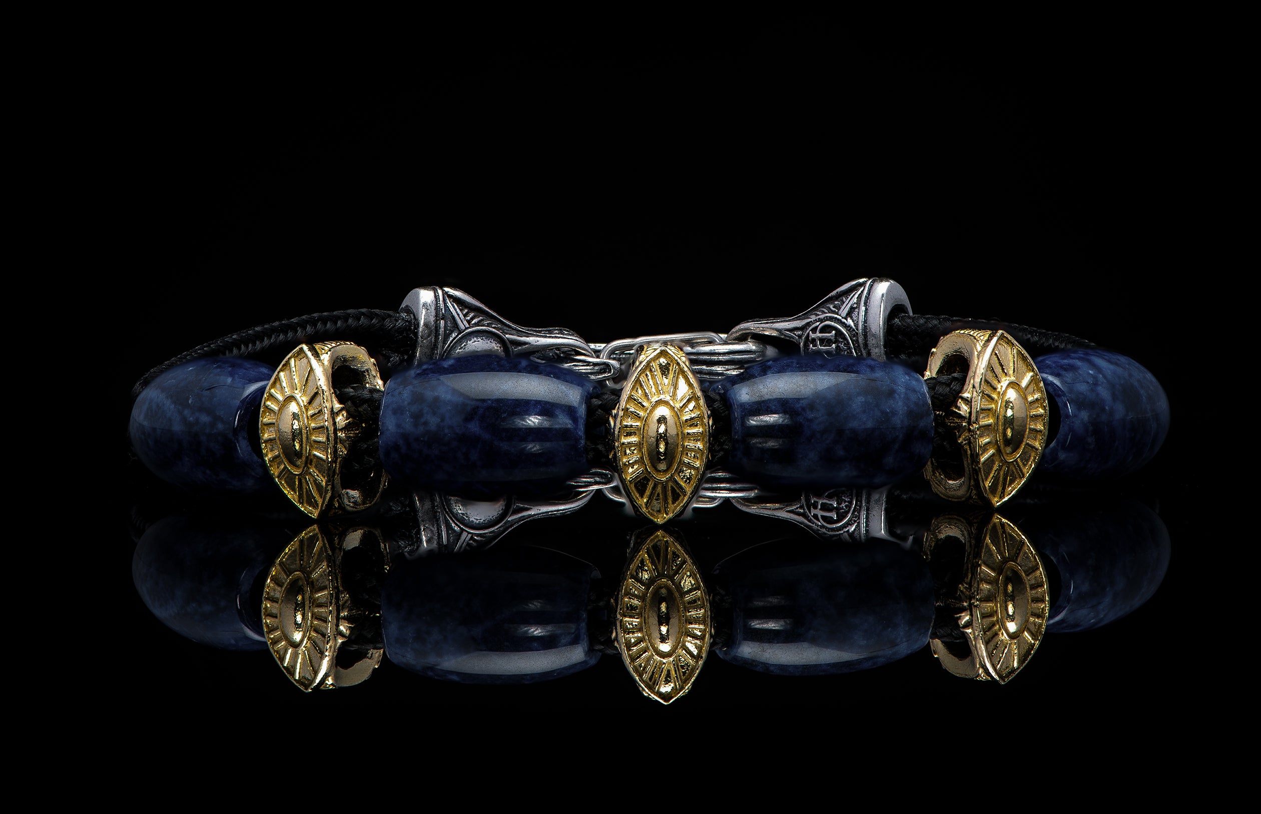 Bracelet featuring sodalite and gold beads with silver clasp