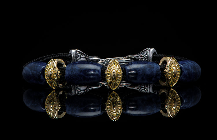Bracelet featuring sodalite and gold beads with silver clasp