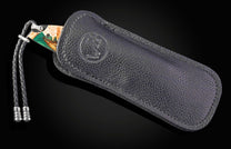 Black leather case with a brand logo on a dark background