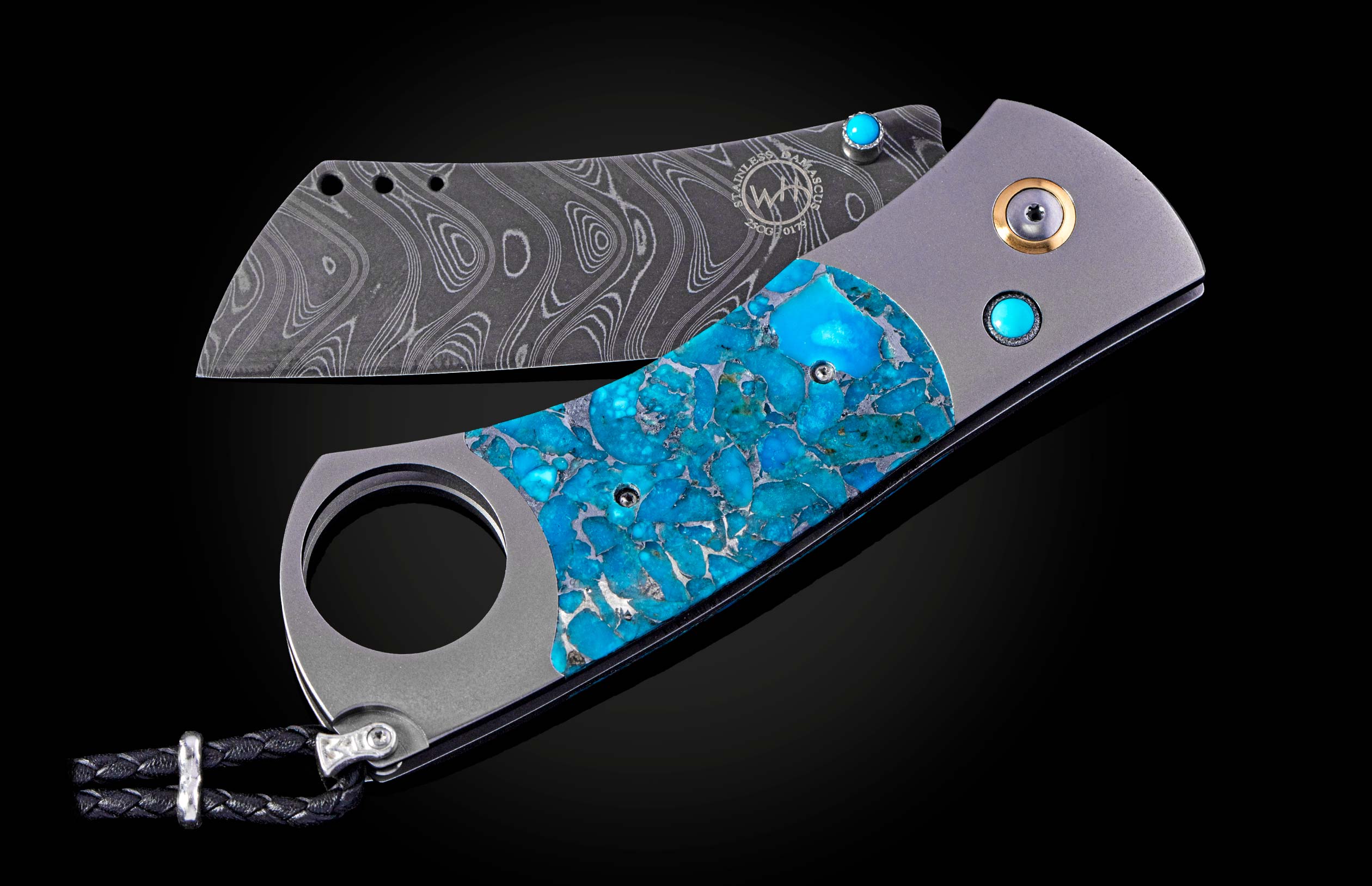 William Henry cigar cutter with turquoise handle and damascus blade on a dark background