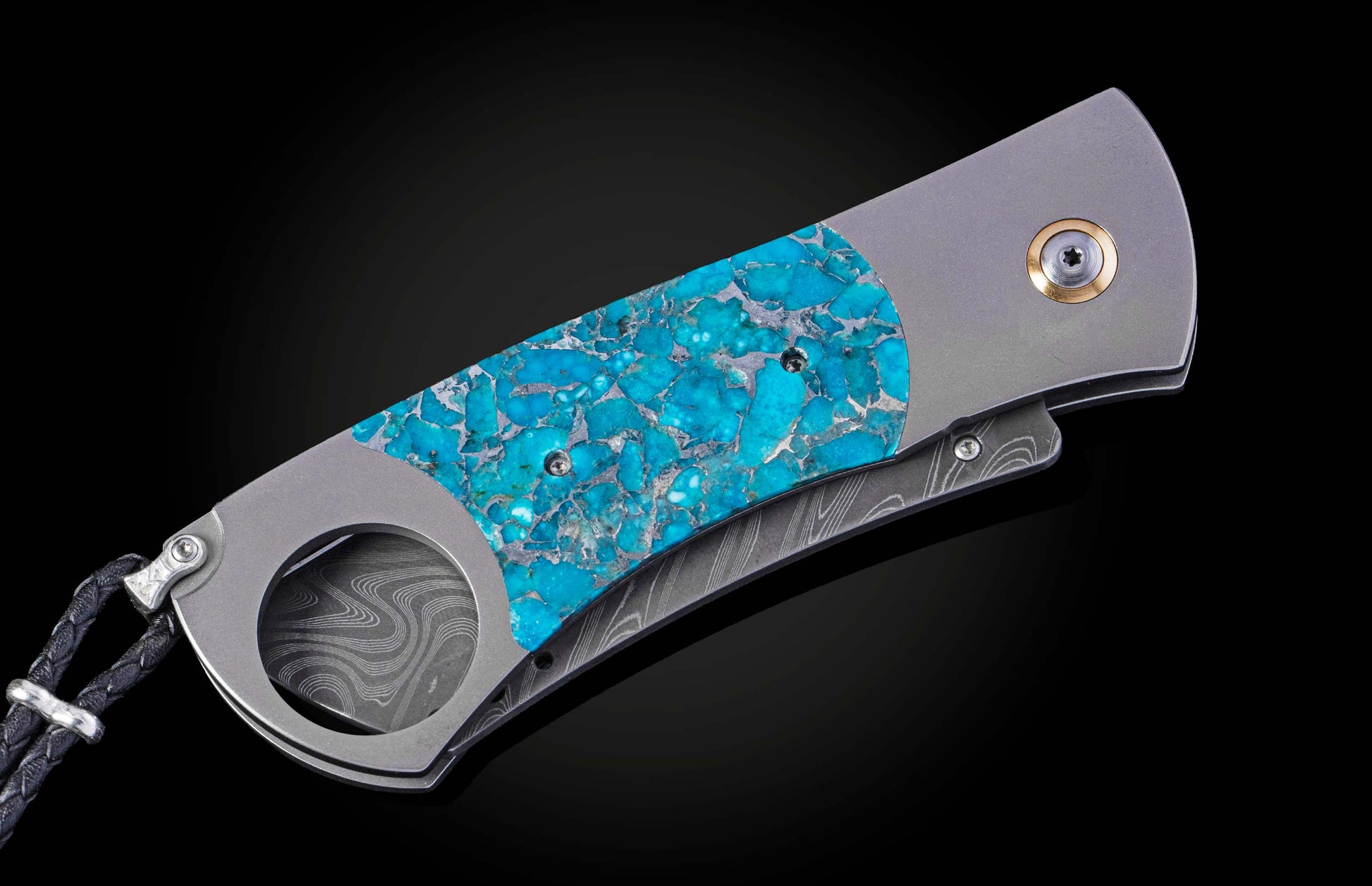 William Henry cigar cutter with turquoise handle and damascus blade on a dark background