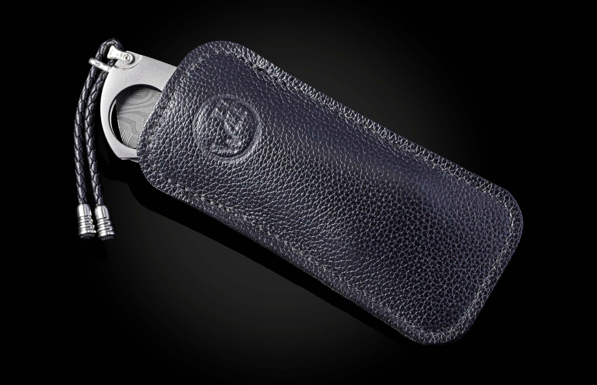 Titanium, carbon fiber, and damascus steel cigar cutter in leather case from William Henry