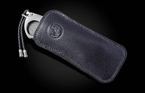 Titanium, carbon fiber, and damascus steel cigar cutter in leather case from William Henry