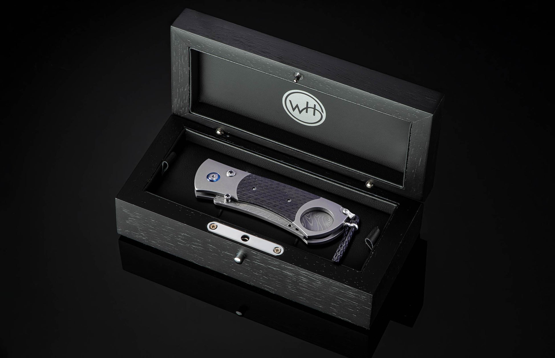 Titanium, carbon fiber, and damascus steel cigar cutter in wooden display case from William Henry
