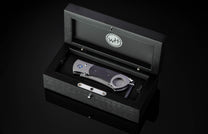 Titanium, carbon fiber, and damascus steel cigar cutter in wooden display case from William Henry