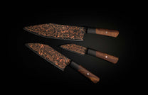 K22-BLK-W|Three black and copper chef knives with swirling rose patterns on blades, dark wood handles, and black bolsters.