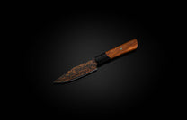 K22S-BLK-W| steak knife on black backgroundSteak knife with black blade, rose gold spiral pattern, and a rich brown wooden handle with a green pin.