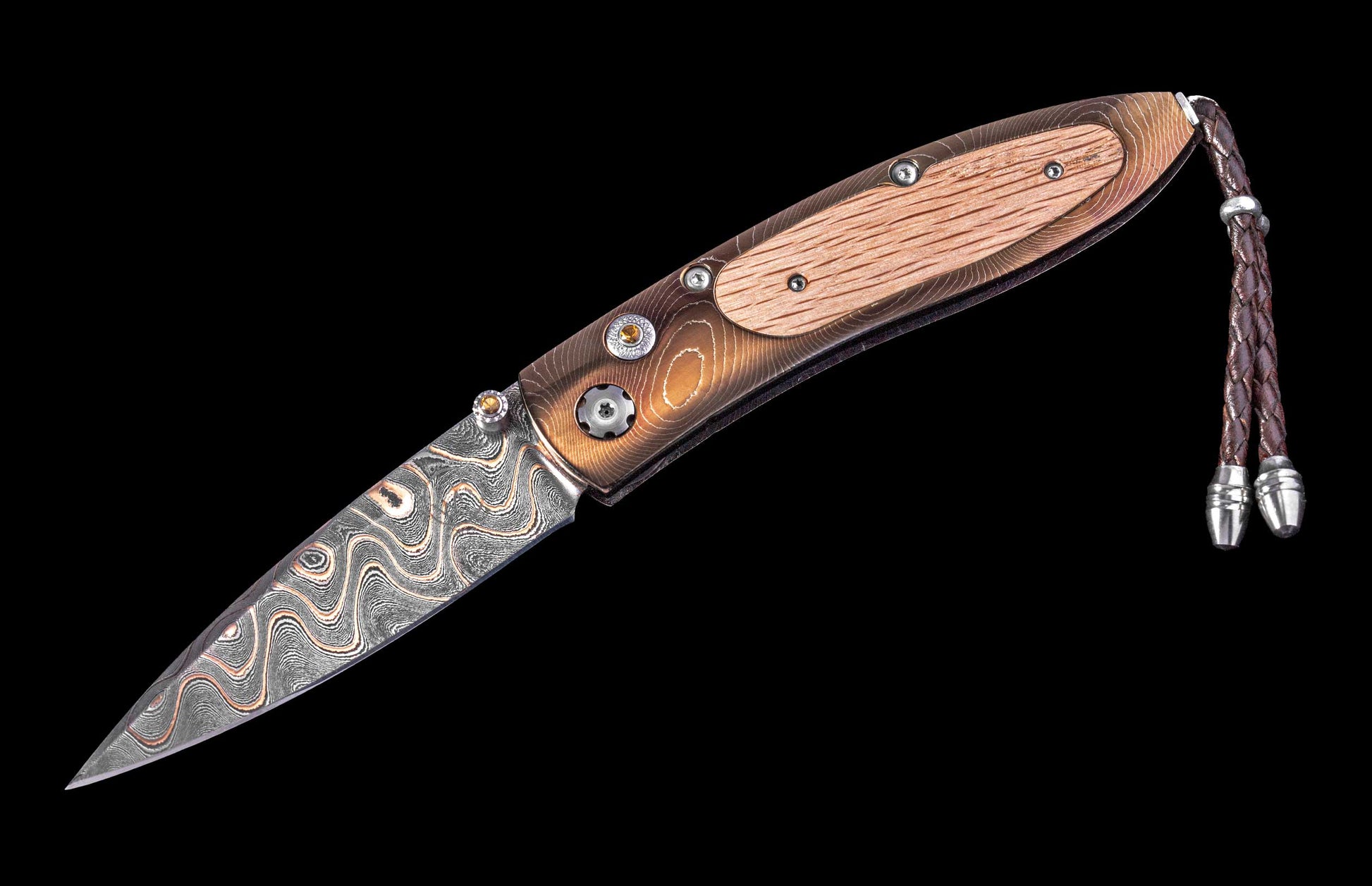 Folding knife with wooden handle and decorative blade on a black background