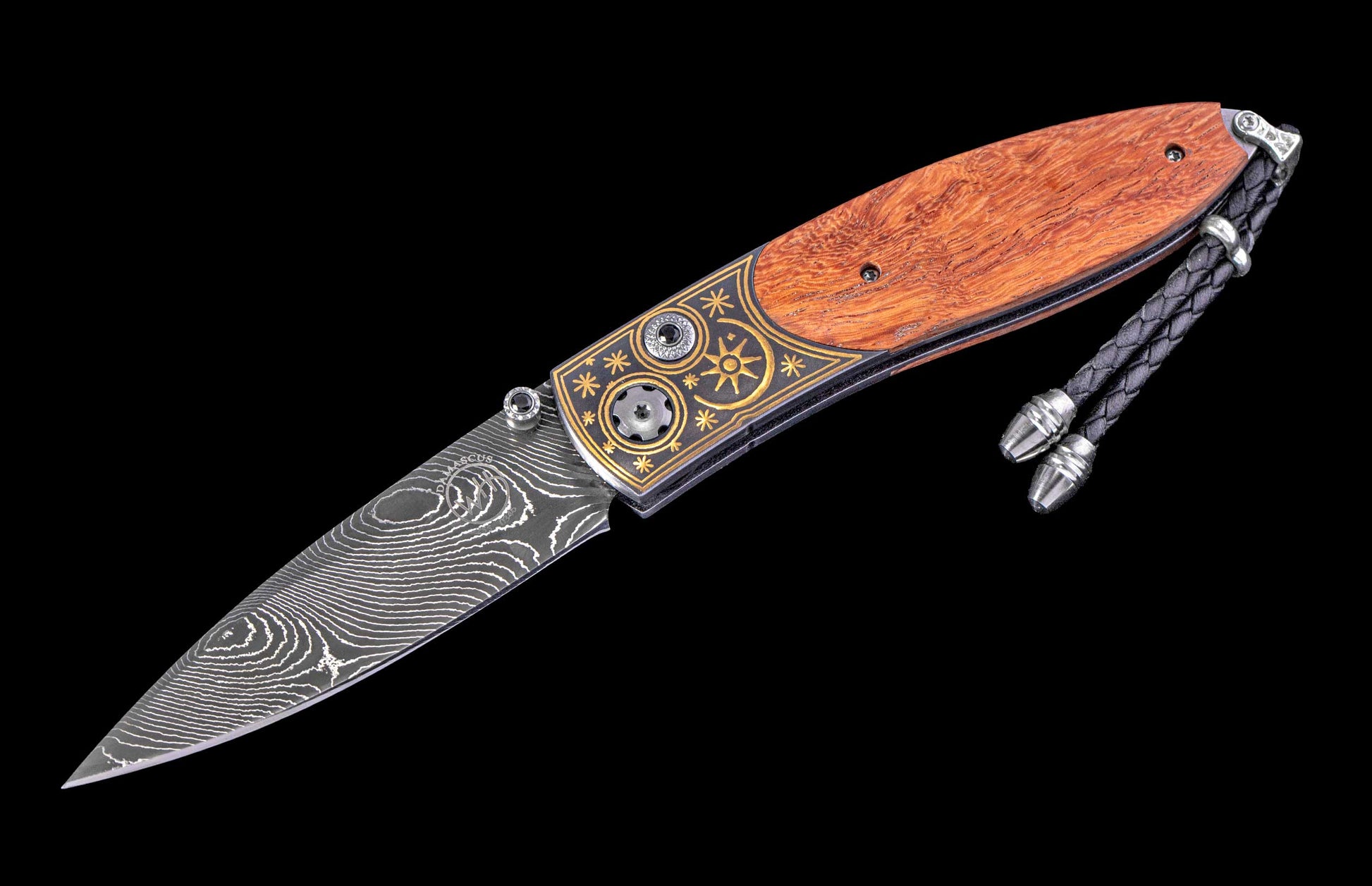 Decorative knife with wooden handle and damascus steel blade on a black background