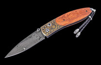 Decorative knife with wooden handle and damascus steel blade on a black background