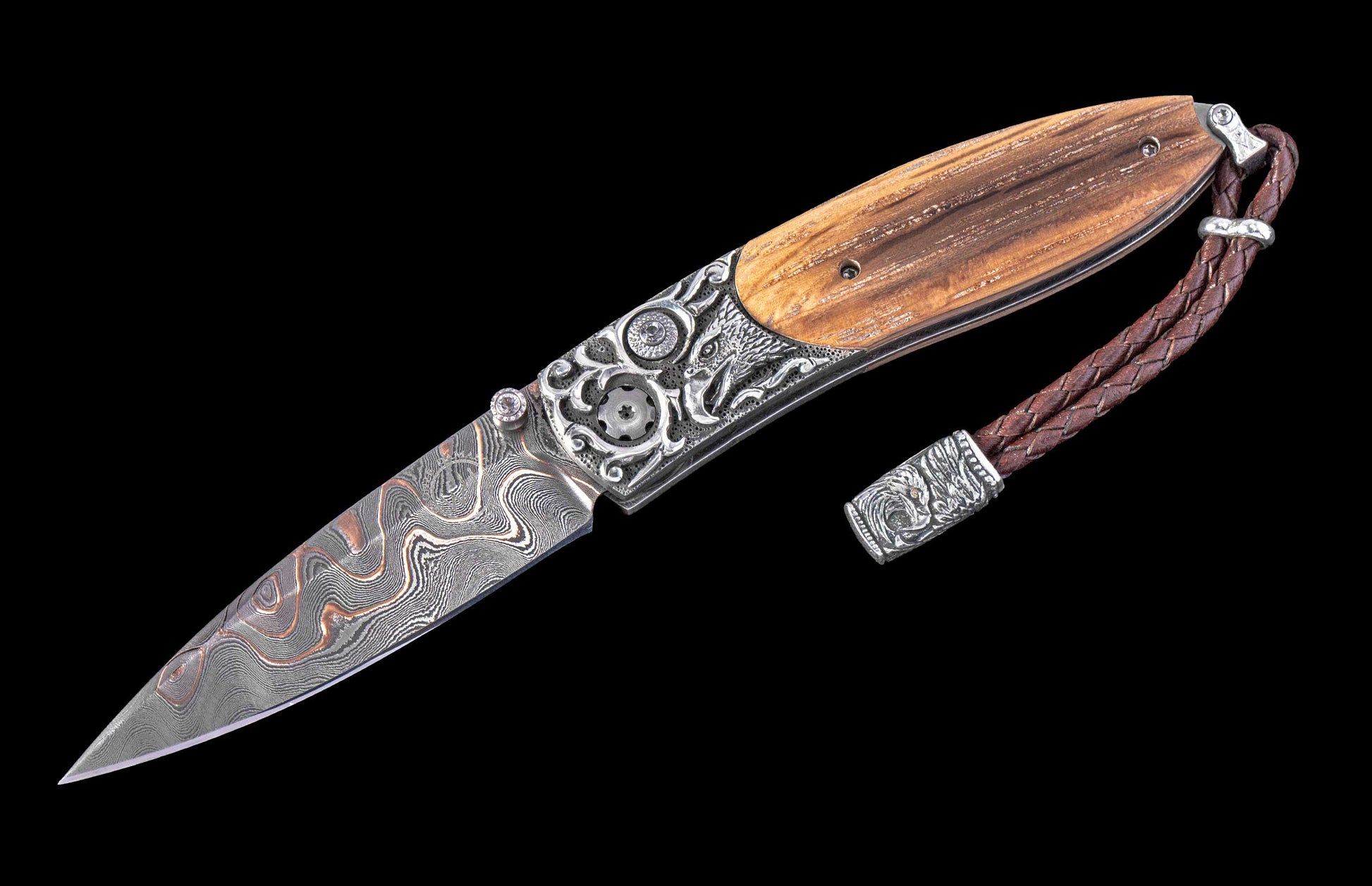 Decorative folding knife with wooden handle and damascus steel blade on a black background