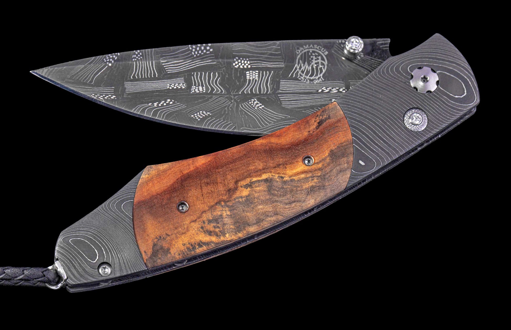 Folding knife with wooden handle and damascus blade on a black background