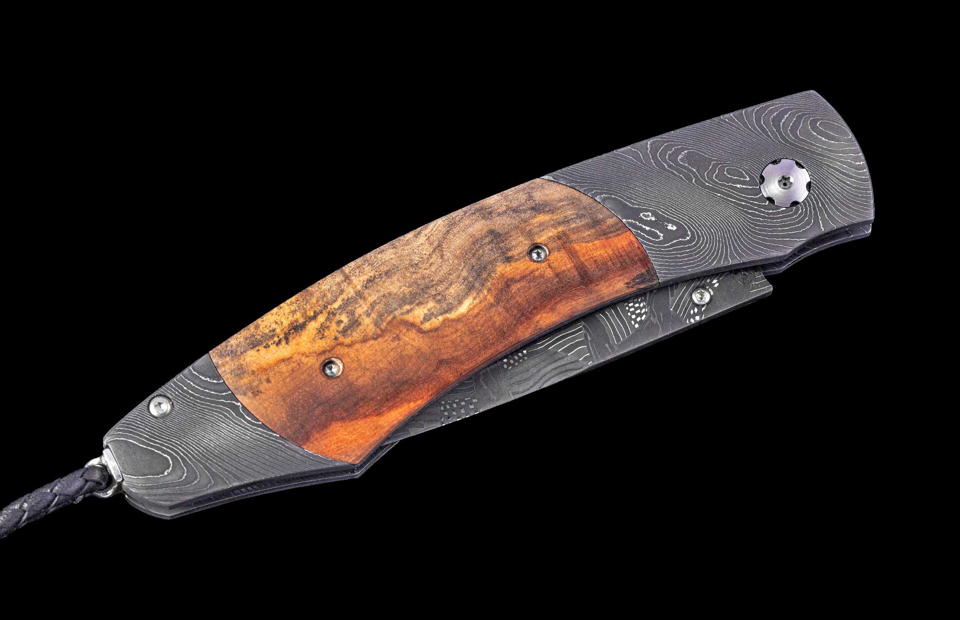 Folding knife with wooden handle and damascus blade on a black background
