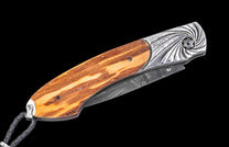 Folding knife with wooden handle and decorative blade on a black background