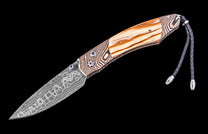 Knife with wooden handle and decorative blade on a black background
