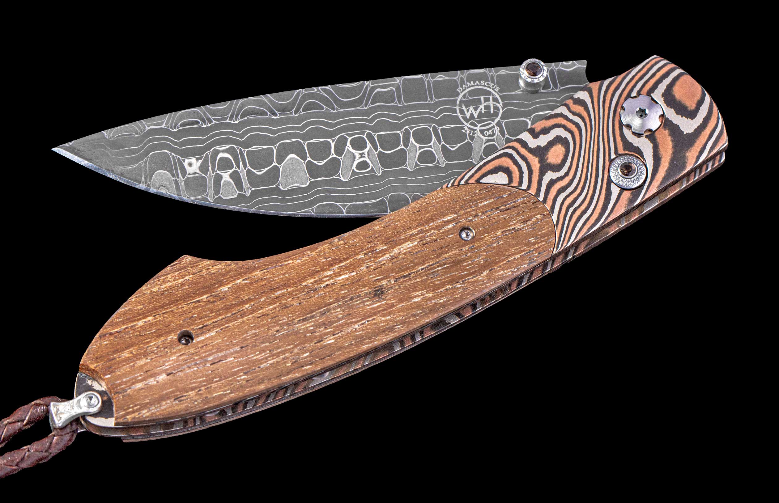Foldable knife with wooden handle and patterned blade on a black background