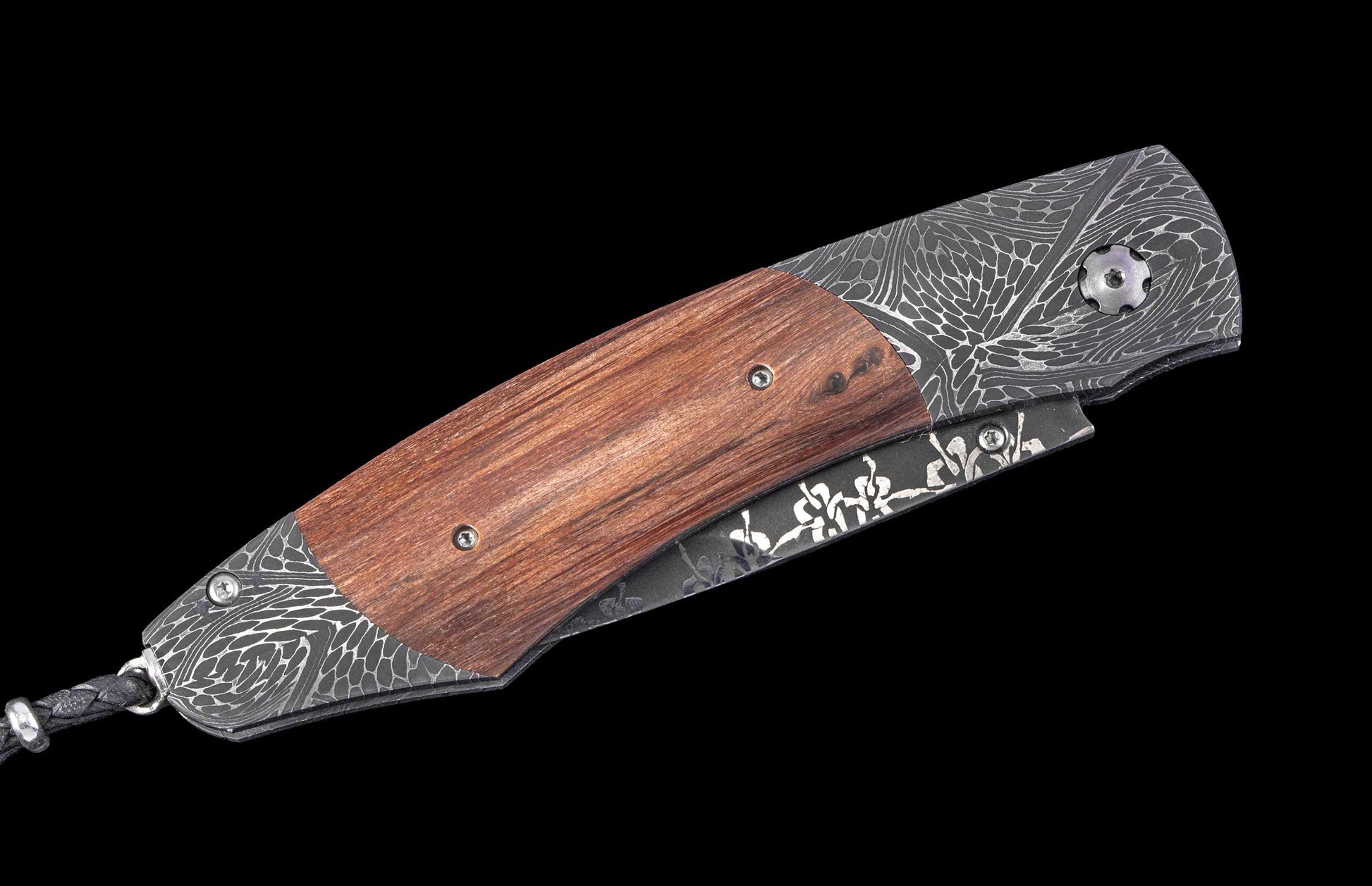 William Henry knife with wooden handle and damascus steel blade on a black background