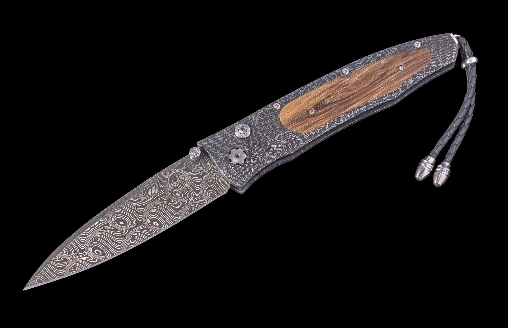 Handmade folding knife with wooden handle and damascus steel blade on a black background