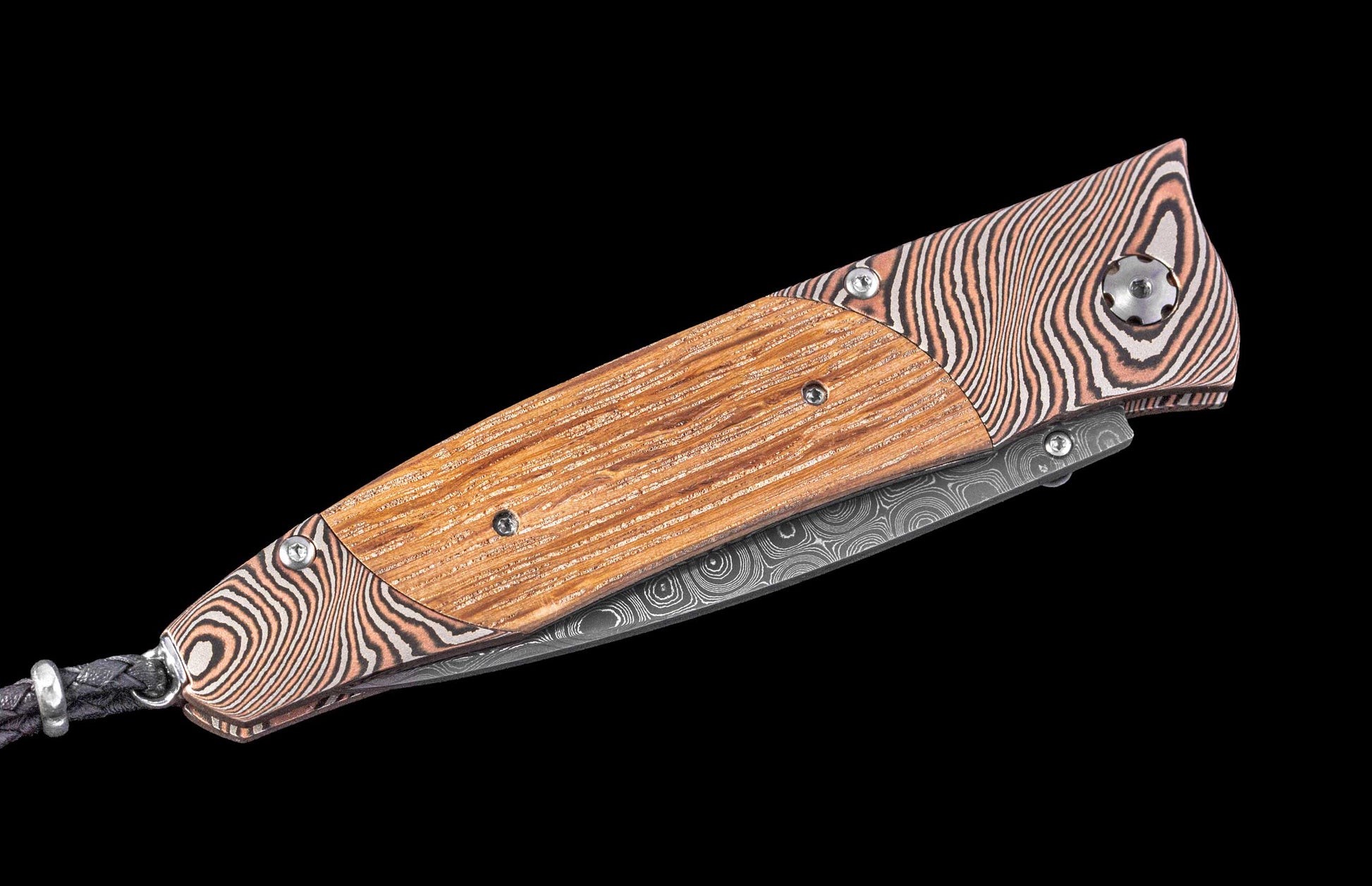Folding knife with wooden handle and Damascus steel blade on a black background
