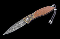 Decorative folding knife with wooden handle and metal blade on a black background