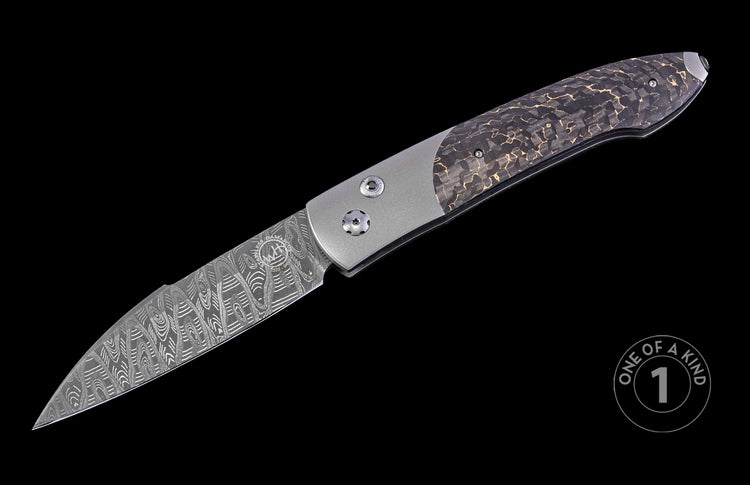 Automatic knife with stainless Damascus steel blade, silver frame, and dark handle with gold shattered pattern.
