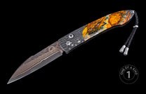 Automatic folding knife with bronze Damascus blade, textured metal bolster, and vibrant orange and yellow stone handle with a black leather lanyard.