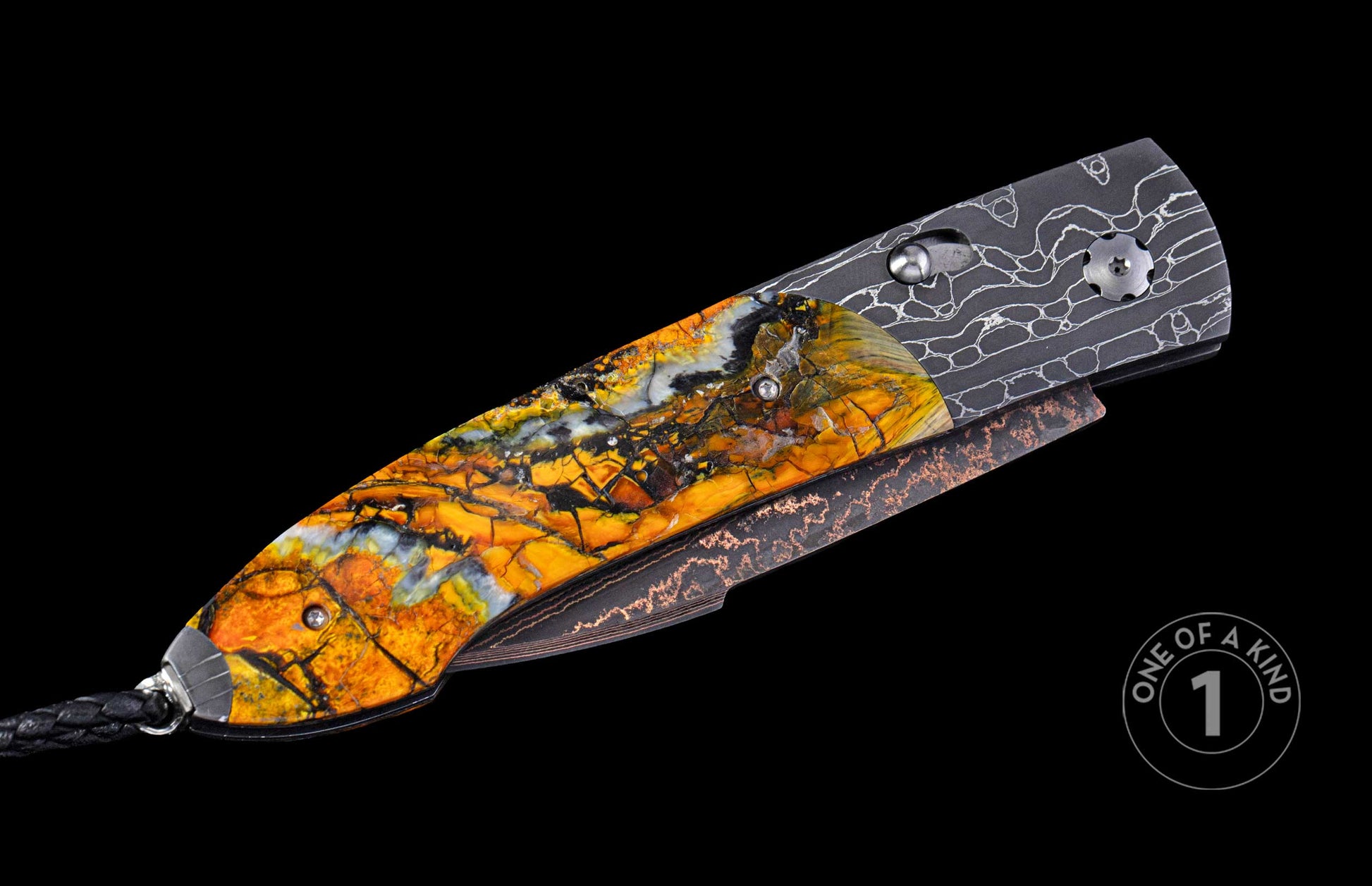 Angled auto knife with a vivid orange, yellow, and black marbled handle, a dark patterned blade with copper accents, and a black cord.