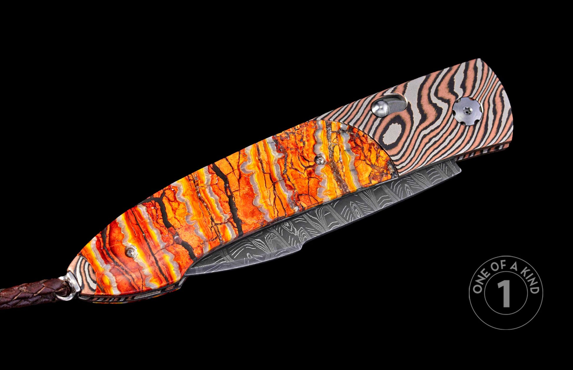 Folding knife with cracked orange and striped metallic handles, a patterned blade, and a brown braided leather lanyard.