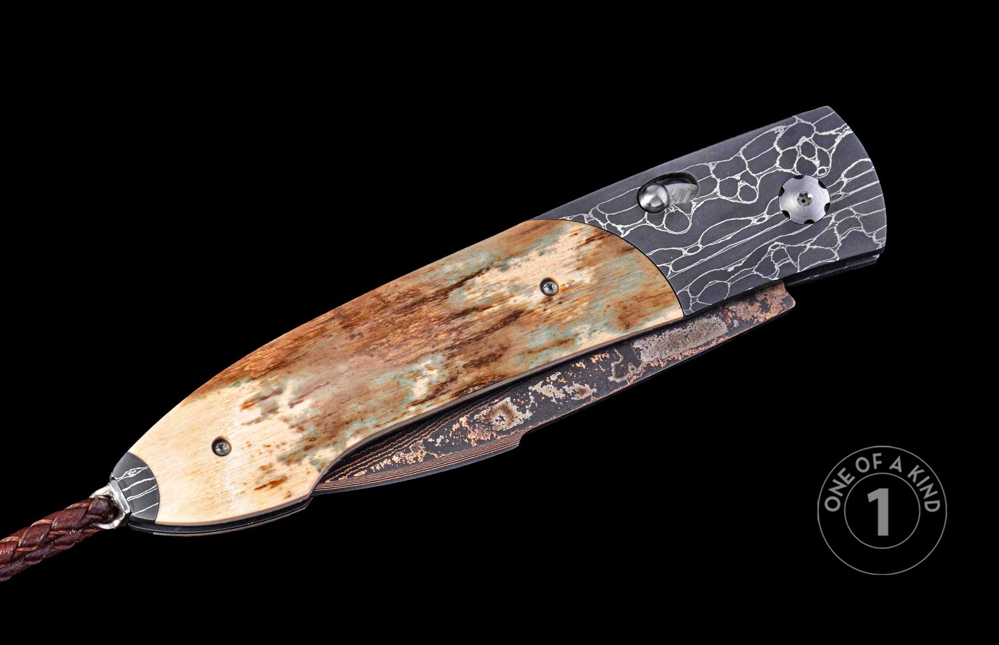 Folding knife with a natural bone handle streaked brown and blue-green, a dark patterned metal frame, a textured bronze-toned blade, and a braided leather lanyard.