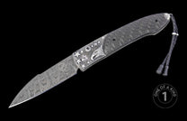 Automatic folding knife with a patterned Damascus blade, silver-toned eagle head and star-embellished handle, carbon fiber scales, and braided leather lanyard.
