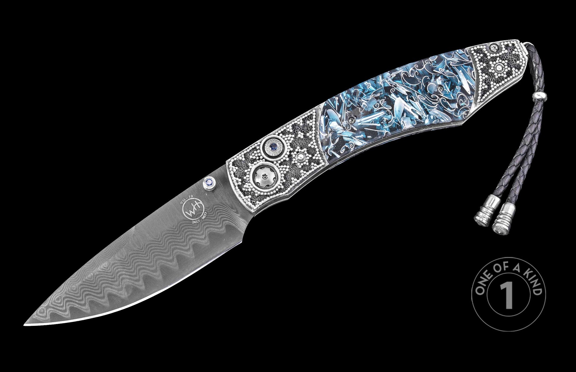 Luxury folding knife with damascus steel blade and blue resin handle, by W.H. Knives, featuring intricate silver inlays and braided lanyard, side view