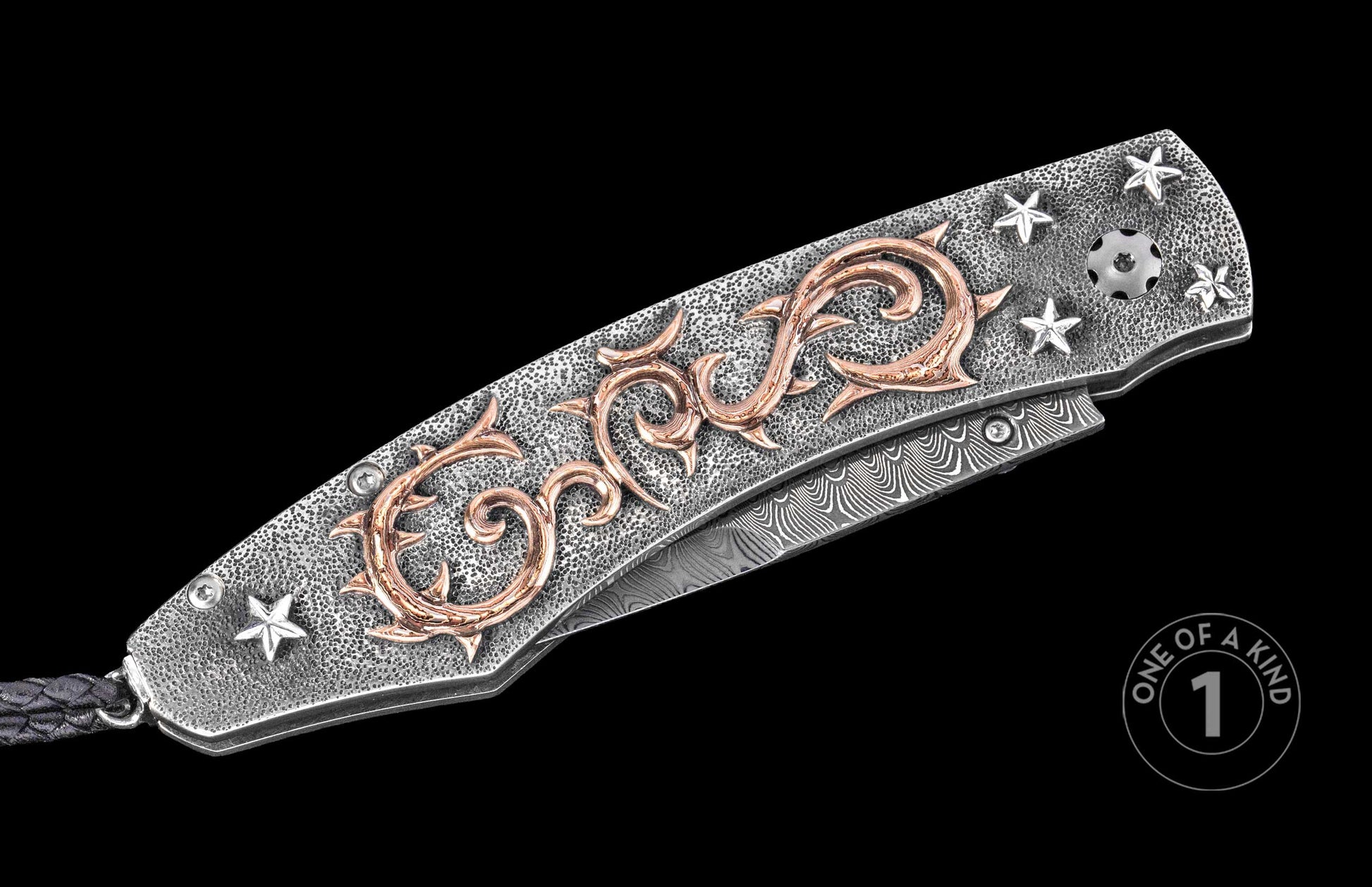 Luxury folding knife with textured silver handle, rose gold thorn motif, and star accents, featuring damascus blade and braided lanyard, side view