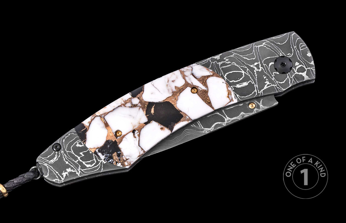 Luxury folding knife with white and black mosaic inlay handle, gold screws, and dark marbled scales, side view on black background