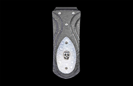 Dark gray money clip with a damascus pattern and a white inlay featuring a silver skull.